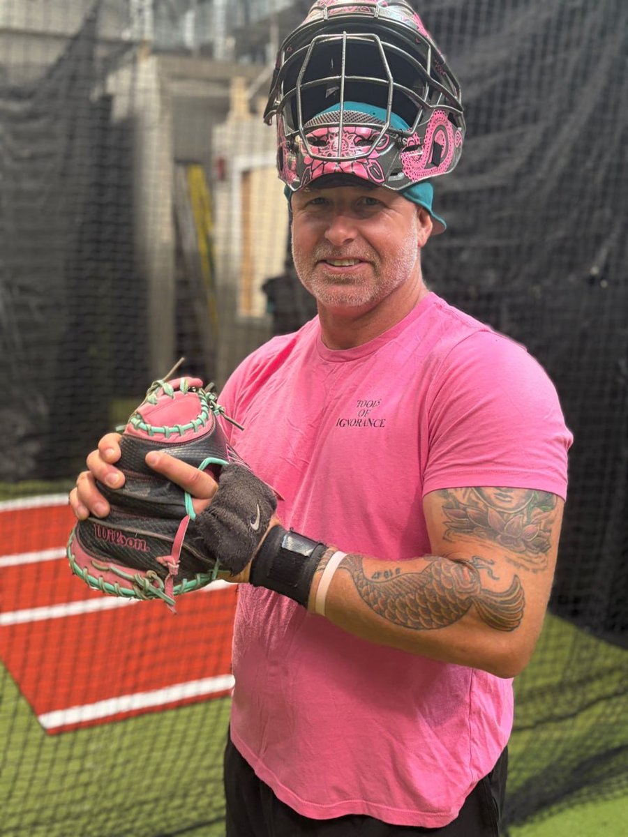 Coach Crosby in catcher's gear at home plate